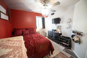 Bedroom with wood finished floors and ceiling fan