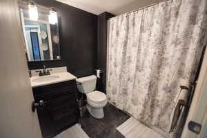 Bathroom featuring a textured ceiling, vanity, and a shower with curtain