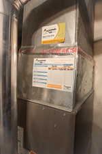 Utility room featuring heating unit