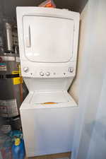 Washroom with stacked washing machine and dryer and secured water heater
