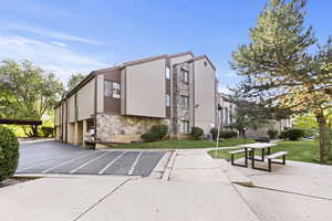 View of building exterior with uncovered parking