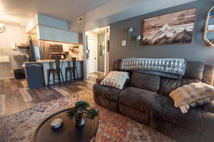 Living room featuring dark wood finished floors and baseboards