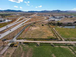 Aerial view of property and surrounding area featuring mountains