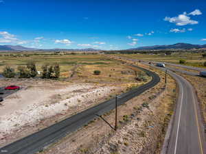 View of asphalt road with a mountain view and a view of rural / pastoral area