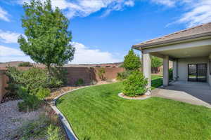 Fenced backyard featuring a patio