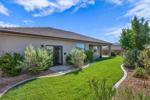 Back of house featuring a tile roof and stucco siding