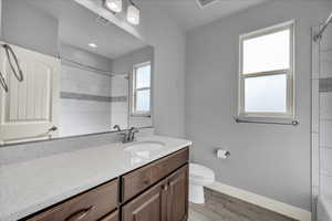 Full bathroom with vanity, light wood-type flooring, and shower / bathtub combination