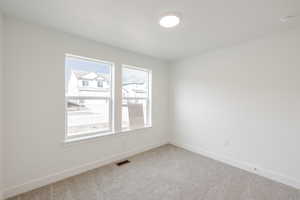 Unfurnished room featuring baseboards and carpet