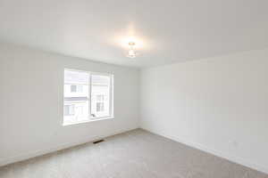 Carpeted empty room with baseboards