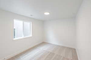Unfurnished room with baseboards and light carpet