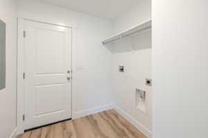 Laundry room featuring light wood-style flooring, washer hookup, and electric dryer hookup