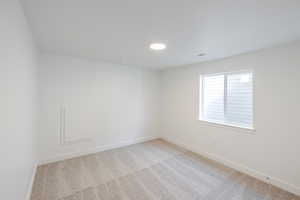 Empty room with baseboards and light carpet