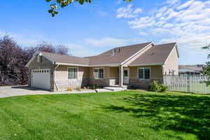 Ranch-style house featuring stucco siding, concrete driveway, a garage, and stone siding