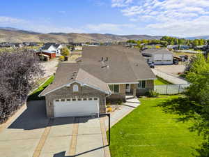 View of front of house featuring brick siding, concrete driveway, a shingled roof, a residential view, and a garage