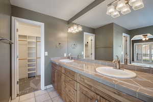 Ensuite primary bath with jetted tub, separate shower and walk in closet