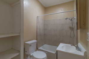 Full bathroom featuring a textured wall, vanity, and washtub / shower combination