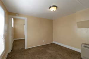 Empty room with carpet and heating unit
