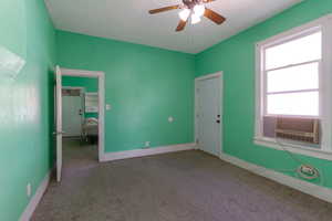 Unfurnished bedroom with carpet flooring and a ceiling fan
