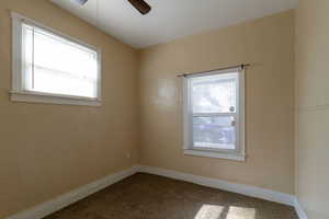 Empty room with carpet and ceiling fan