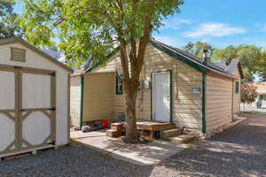 Back of property with a shed