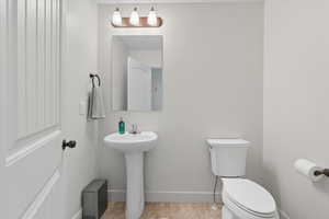 Bathroom with baseboards and light tile patterned flooring