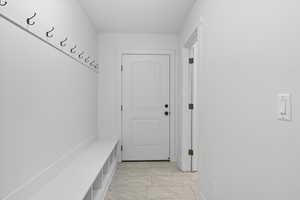 Mudroom with light tile patterned flooring and baseboards