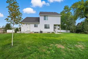 Back of property with a shingled roof and entry steps