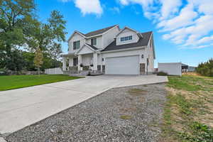 View of front of property with concrete driveway, a porch, a garage, and roof with shingles