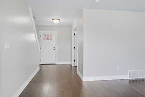 Foyer featuring wood finished floors and baseboards