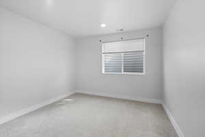 Empty room with carpet floors and baseboards