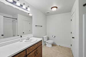 Full bathroom featuring vanity, light tile patterned flooring, and a shower