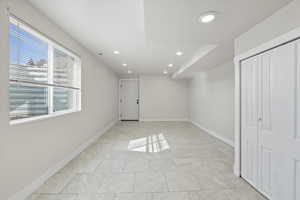 Unfurnished bedroom with recessed lighting, a closet, and light tile patterned flooring