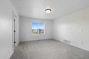 Unfurnished room with light carpet and baseboards