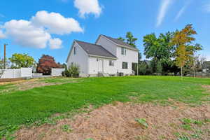 Rear view of house with a shingled roof