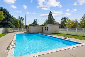 View of swimming pool with a fenced backyard and a patio
