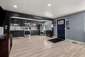 Kitchen featuring stainless steel appliances, recessed lighting, light wood finished floors, and light countertops