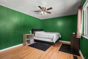 Bedroom featuring wood finished floors and ceiling fan