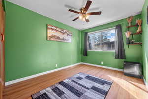 Unfurnished bedroom with wood finished floors and ceiling fan