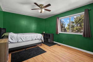 Bedroom featuring wood finished floors and ceiling fan