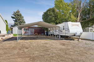 View of parking featuring a carport