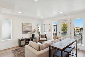 Living room featuring recessed lighting, light wood-style floors, and a textured ceiling