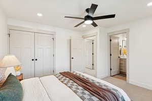 Carpeted bedroom with a closet, recessed lighting, ceiling fan, and connected bathroom