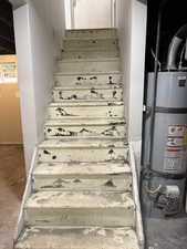 Staircase with strapped water heater