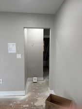 Hallway featuring baseboards