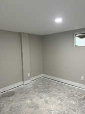 Basement with baseboards and recessed lighting