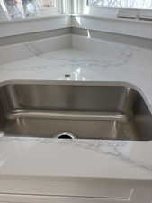 Kitchen view of light stone counters