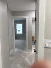 Corridor featuring a textured wall