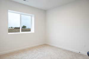 Empty room with light colored carpet