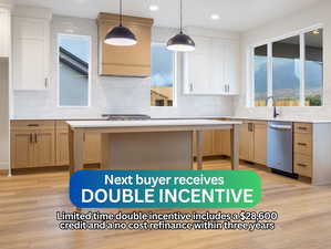Kitchen featuring tasteful backsplash, light wood-type flooring, light stone countertops, stainless steel dishwasher, and recessed lighting