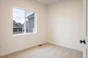Carpeted empty room with baseboards